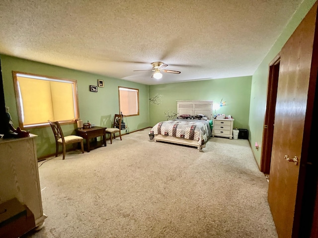 carpeted bedroom featuring ceiling fan and a textured ceiling