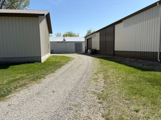 5114 46th St, Merton Twp, MN 55060 - view of home's exterior featuring an outbuilding, a garage, and gravel driveway