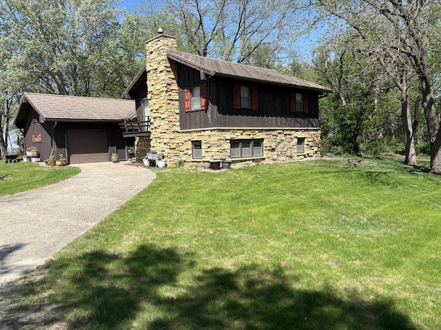 5114 46th St, Merton Twp, MN 55060 - view of front of property featuring a chimney, a garage, a front yard, and board and batten siding