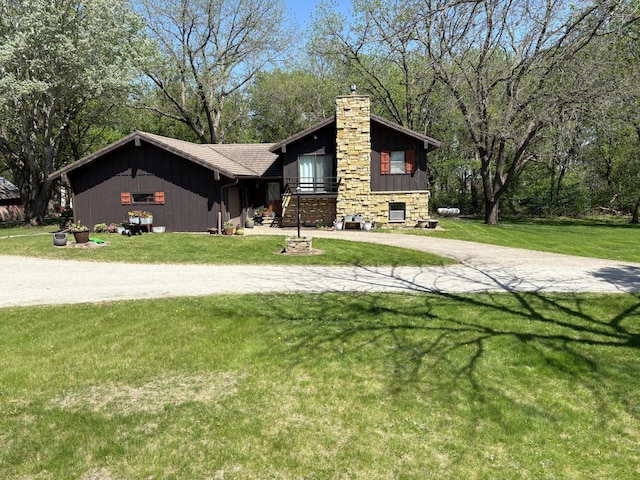 5114 46th St, Merton Twp, MN 55060 - view of front of property with a chimney, driveway, a front lawn, and board and batten siding