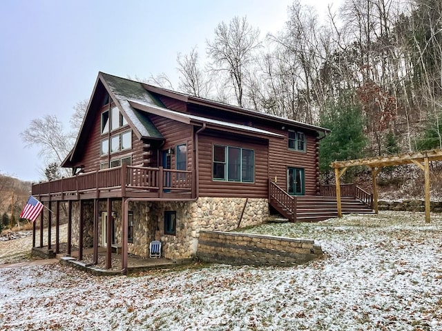 snow covered property featuring a deck