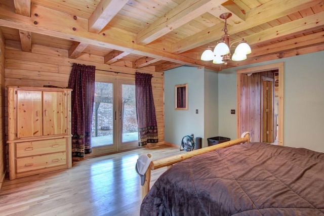 bedroom with french doors, wood ceiling, an inviting chandelier, beamed ceiling, and light hardwood / wood-style floors