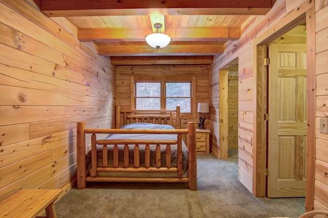 carpeted bedroom featuring beam ceiling, wooden walls, and wood ceiling