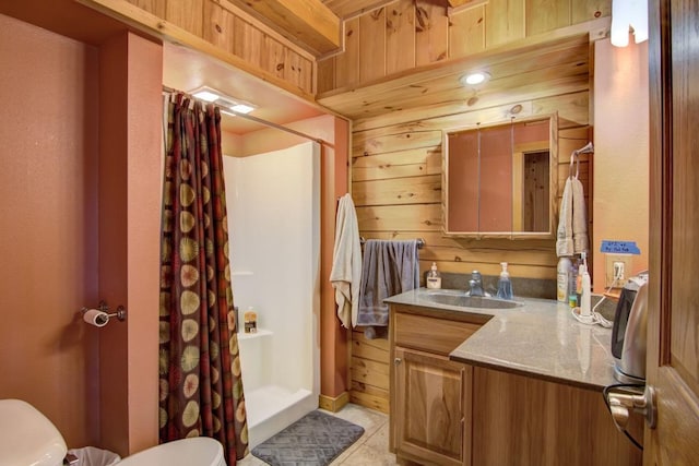 bathroom with a shower with shower curtain, tile patterned floors, vanity, toilet, and wood walls