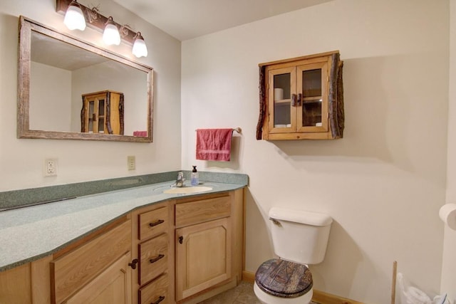 bathroom featuring tile patterned floors, vanity, and toilet