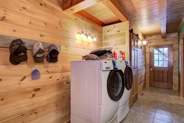 clothes washing area with wooden ceiling, wooden walls, and washing machine and clothes dryer