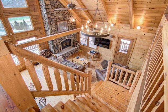 stairway featuring beamed ceiling, wooden ceiling, a fireplace, and hardwood / wood-style flooring