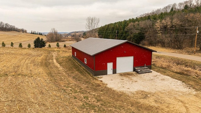 view of outbuilding featuring a rural view and a garage