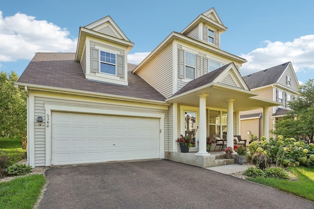 view of front of property with a porch and a garage