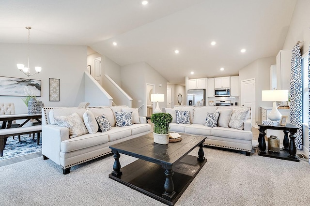 living room featuring a notable chandelier, light carpet, and vaulted ceiling