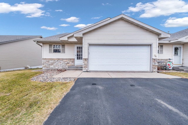 single story home featuring a garage and a front lawn