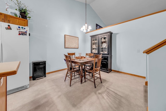 dining area featuring a chandelier and lofted ceiling