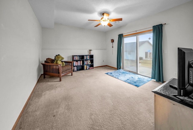 sitting room featuring light carpet and ceiling fan