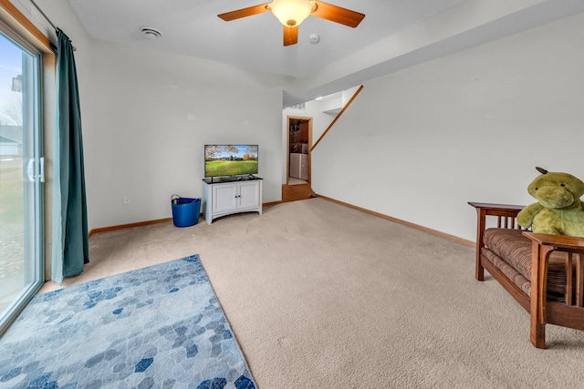 sitting room with light colored carpet, a wealth of natural light, and ceiling fan