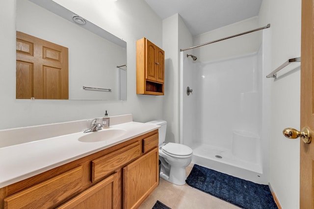 bathroom featuring vanity, toilet, and a shower