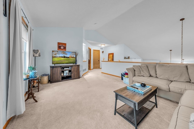 carpeted living room with lofted ceiling