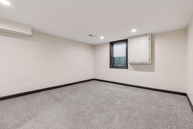 unfurnished room featuring light colored carpet