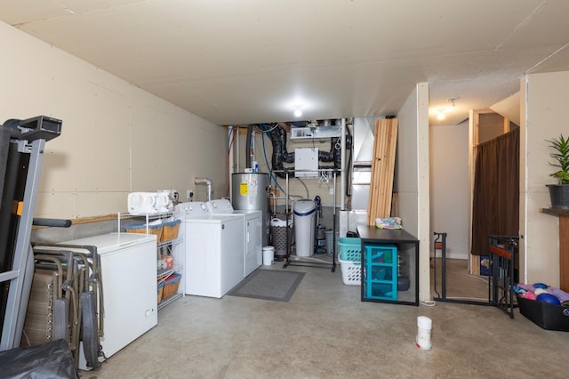 basement with water heater, washer and clothes dryer, and refrigerator