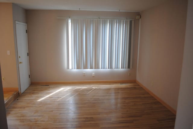 spare room with light wood-type flooring