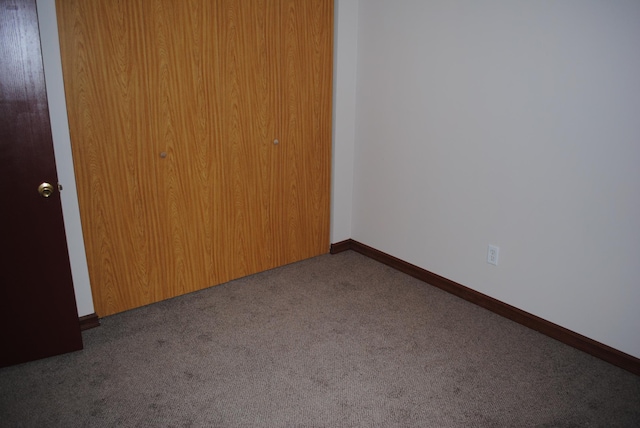 unfurnished bedroom featuring a closet and carpet