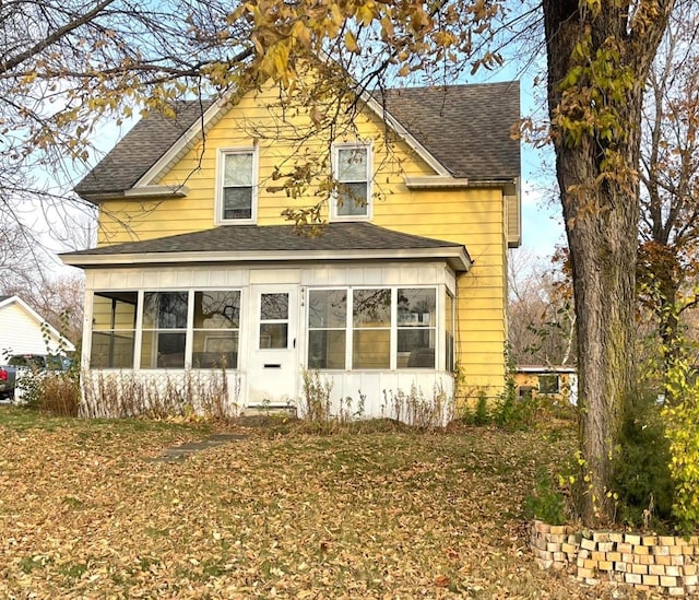 view of front of house featuring a sunroom