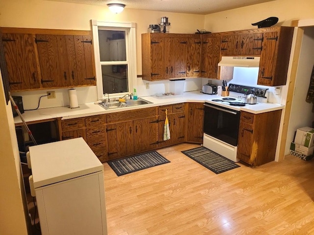 kitchen featuring white electric range oven, a textured ceiling, light wood-type flooring, and sink