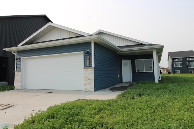 3743 33rd St S, Moorhead, MN 56560 - ranch-style house featuring board and batten siding, a garage, stone siding, and driveway