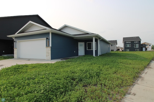 3743 33rd St S, Moorhead, MN 56560 - single story home featuring board and batten siding, a garage, driveway, and a front lawn