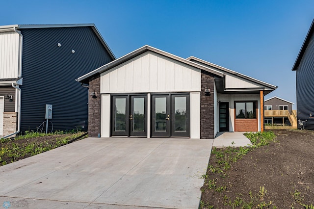 3743 33rd St S, Moorhead, MN 56560 - view of front of property featuring stone siding, board and batten siding, and french doors