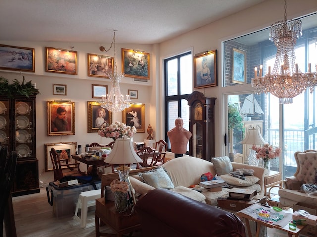 living room featuring a textured ceiling, an inviting chandelier, vaulted ceiling, and hardwood / wood-style flooring