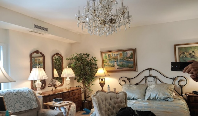 bedroom featuring an inviting chandelier