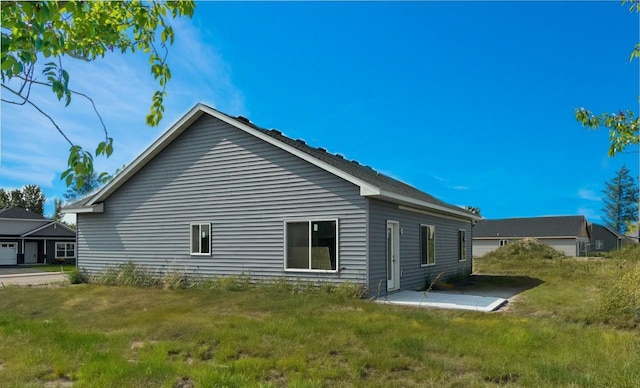 view of side of property featuring a patio area and a yard