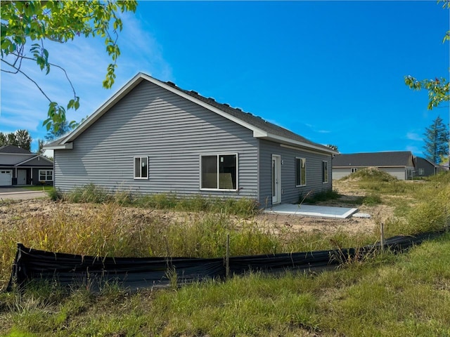 view of side of property featuring a patio area