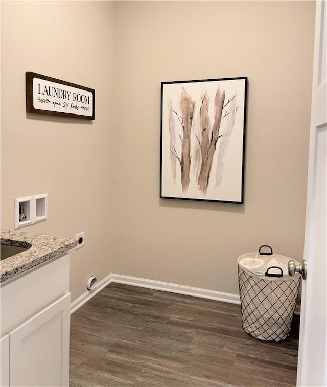 laundry area featuring cabinets, hookup for an electric dryer, dark hardwood / wood-style flooring, and hookup for a washing machine