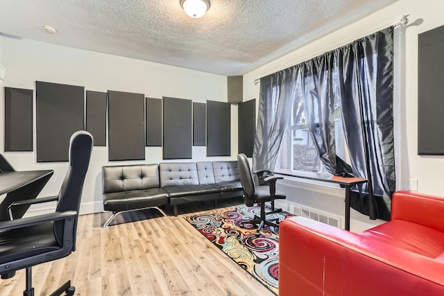 interior space featuring hardwood / wood-style flooring and a textured ceiling