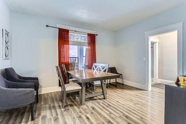 dining space with light hardwood / wood-style flooring