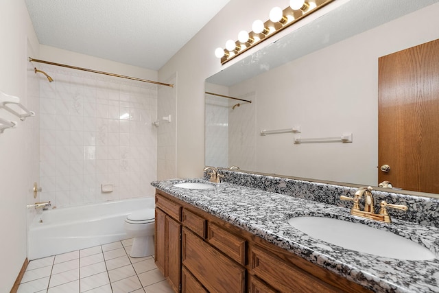 full bathroom featuring a textured ceiling, tiled shower / bath combo, tile patterned floors, vanity, and toilet