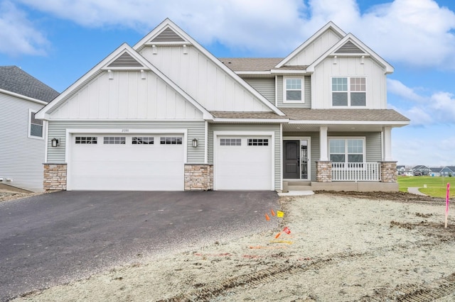 craftsman-style home with covered porch and a garage