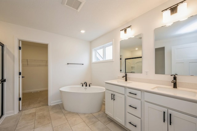 bathroom with tile patterned floors, vanity, and shower with separate bathtub