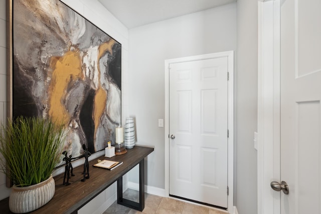 doorway to outside with light tile patterned floors