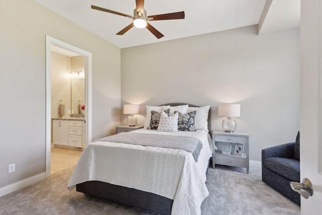 bedroom featuring light carpet, connected bathroom, and ceiling fan