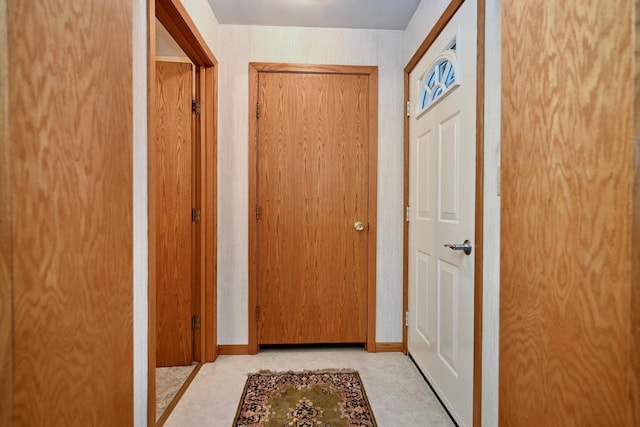 doorway to outside with light tile patterned flooring