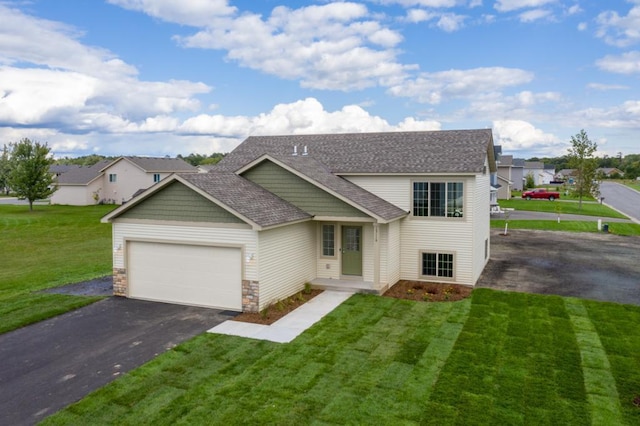 view of front facade with a front yard and a garage