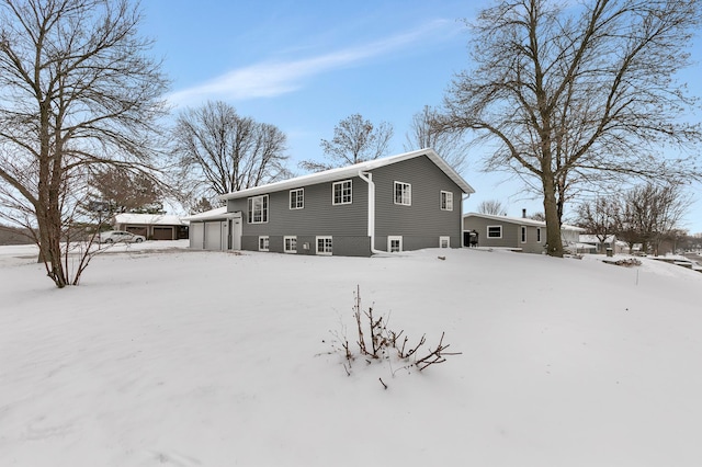 snow covered property featuring a garage