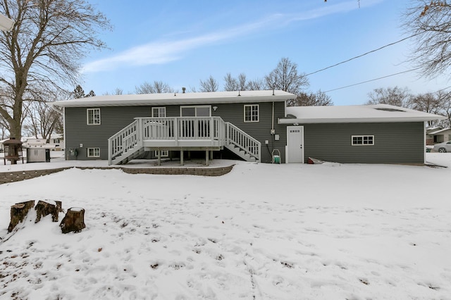 snow covered property featuring a deck