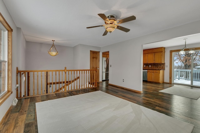 empty room featuring ceiling fan and dark wood-type flooring