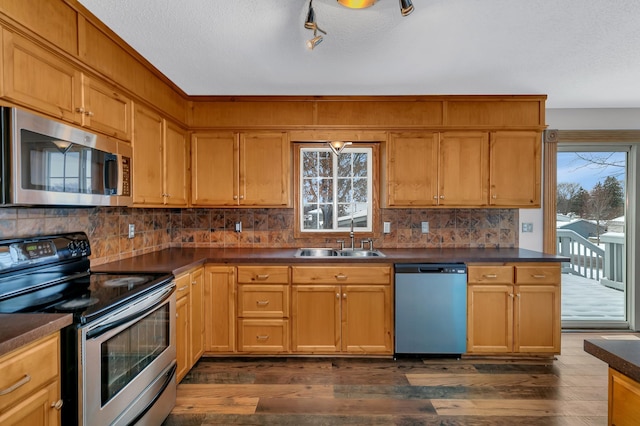 kitchen featuring decorative backsplash, sink, dark hardwood / wood-style floors, and appliances with stainless steel finishes