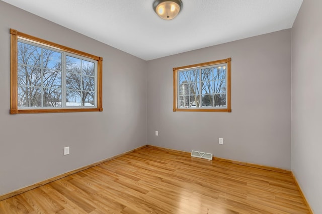 spare room with light wood-type flooring