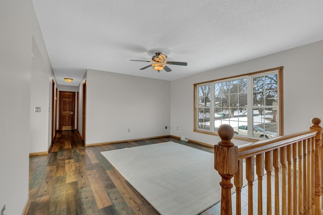 empty room featuring dark hardwood / wood-style floors and ceiling fan