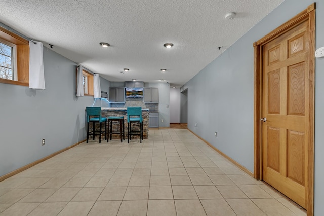 tiled dining area featuring a textured ceiling